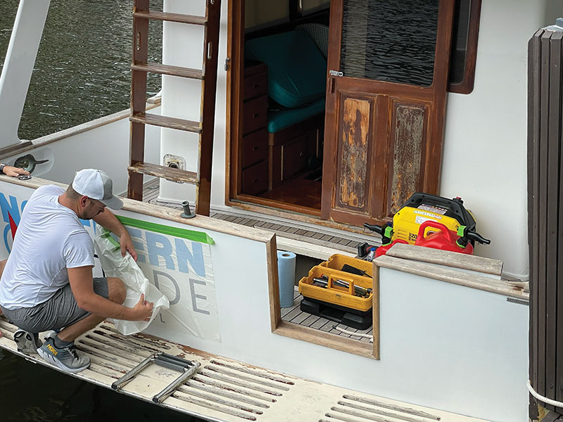 Putting-On-Our-Boat-Name