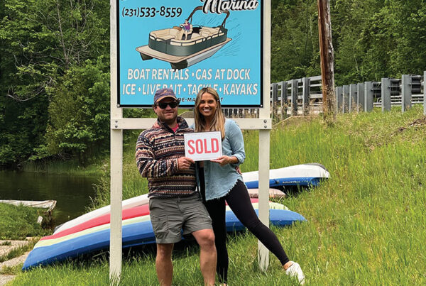 Riverside Marina Kenny Anderson and Wife in front of sign