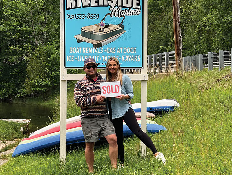 Riverside Marina Kenny Anderson and Wife in front of sign